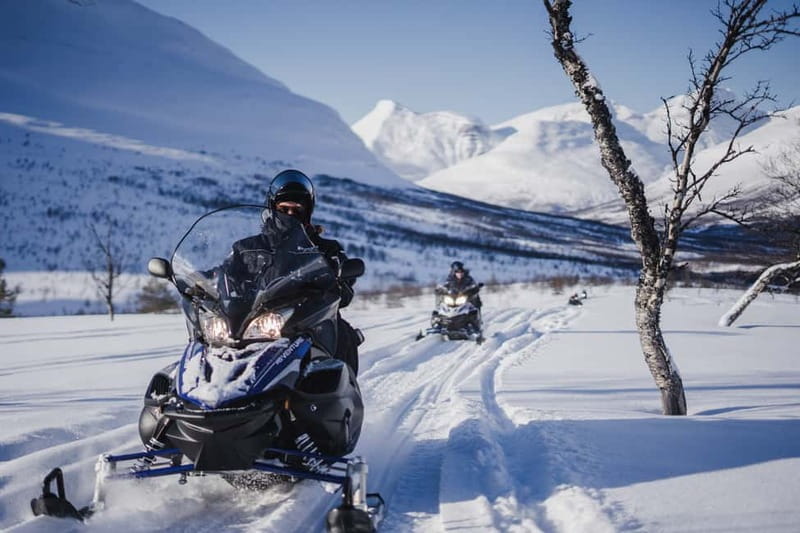From Tromsø: Snowmobiling at Camp Tamok & Snow Park Visit - Riding the snowmobile through Tamok Valley